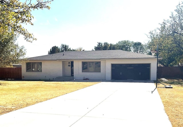 ranch-style house featuring a garage and a front lawn