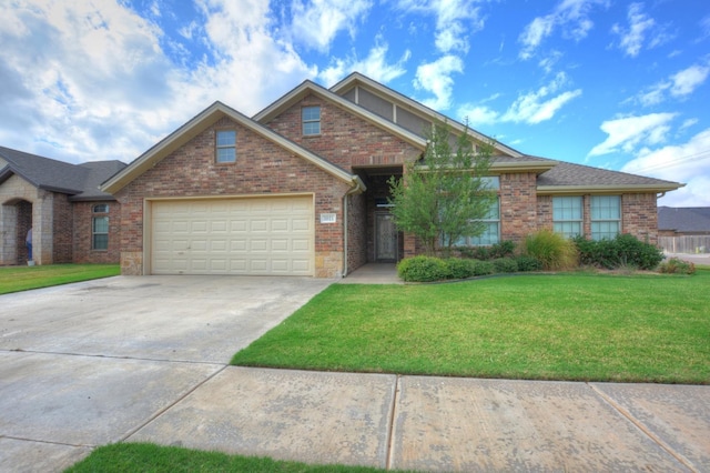 view of front of home featuring a garage and a front yard