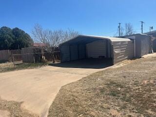 6423 22nd St, Lubbock, TX 79407 - view of outbuilding featuring a carport and driveway