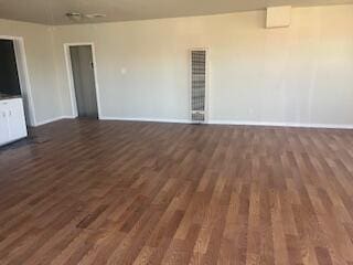 6423 22nd St, Lubbock, TX 79407 - unfurnished living room featuring dark wood-type flooring and baseboards