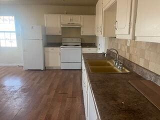 6423 22nd St, Lubbock, TX 79407 - kitchen featuring range, freestanding refrigerator, dark wood-style flooring, dark countertops, and white cabinets