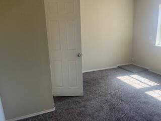 6423 22nd St, Lubbock, TX 79407 - carpeted empty room featuring baseboards