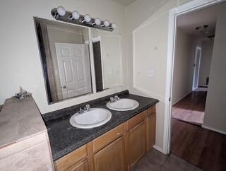 6423 22nd St, Lubbock, TX 79407 - bathroom featuring double vanity and tile patterned floors