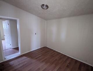 6423 22nd St, Lubbock, TX 79407 - spare room featuring wood finished floors and baseboards