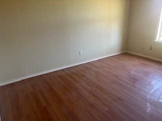 6423 22nd St, Lubbock, TX 79407 - empty room with wood finished floors and baseboards