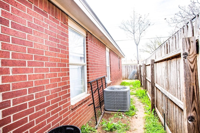 view of side of home featuring central AC