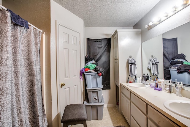 bathroom featuring vanity and a textured ceiling