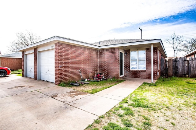 single story home featuring a garage and a front yard