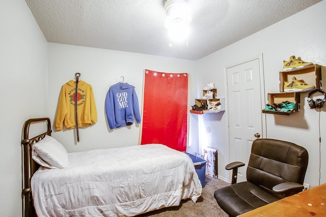 bedroom with carpet and a textured ceiling