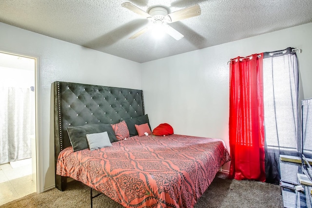 bedroom featuring carpet floors, a textured ceiling, and ceiling fan