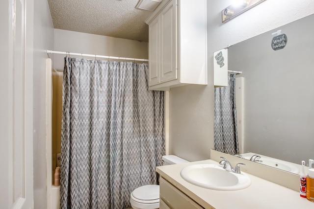 bathroom featuring vanity, toilet, curtained shower, and a textured ceiling