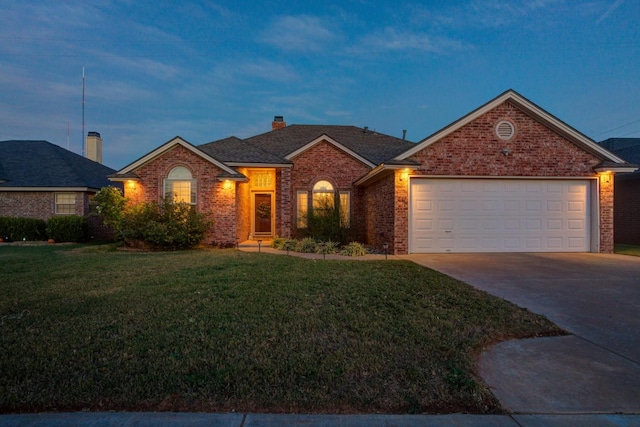 single story home with a garage and a lawn