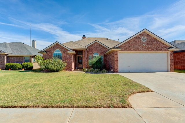 view of front of property featuring a garage and a front yard