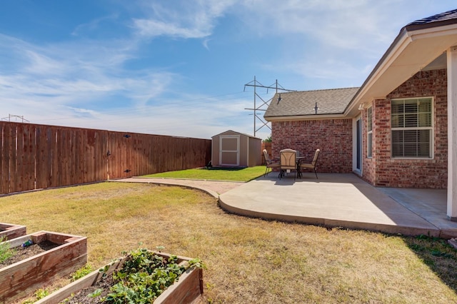 view of yard featuring a storage shed and a patio area