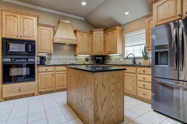 kitchen featuring premium range hood, sink, dark stone countertops, a center island, and black appliances