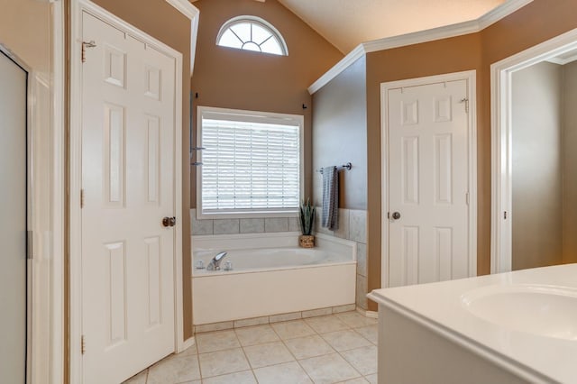 bathroom with vaulted ceiling, tile patterned flooring, ornamental molding, vanity, and a washtub