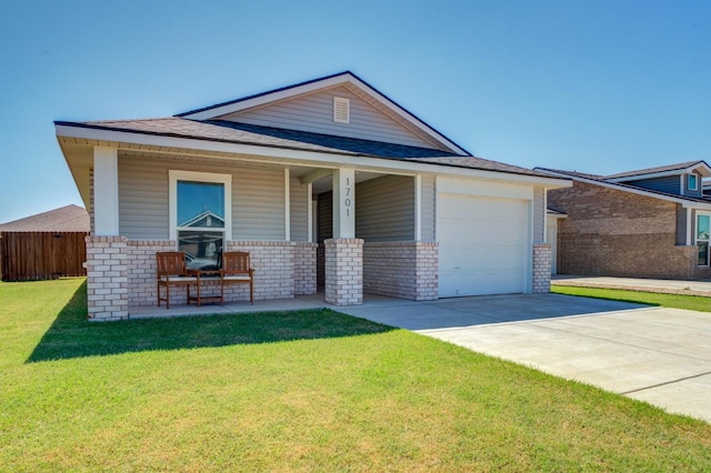 view of front of property with a porch, a garage, and a front yard