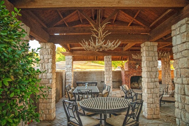 view of patio featuring an outdoor stone fireplace