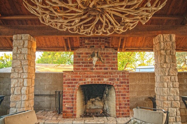 view of patio with an outdoor brick fireplace