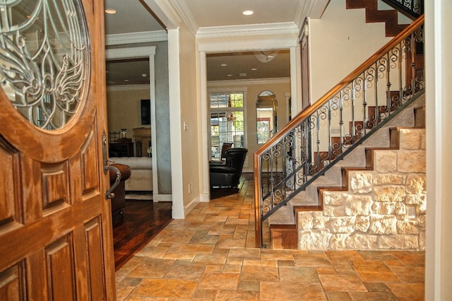 foyer entrance featuring ornamental molding