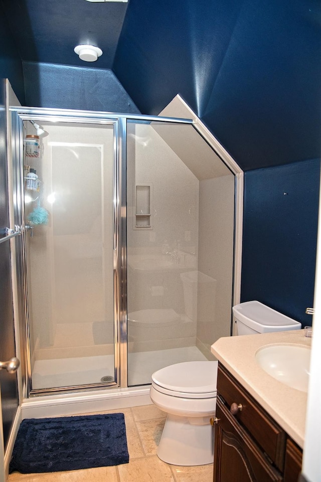 bathroom with vanity, vaulted ceiling, walk in shower, and toilet