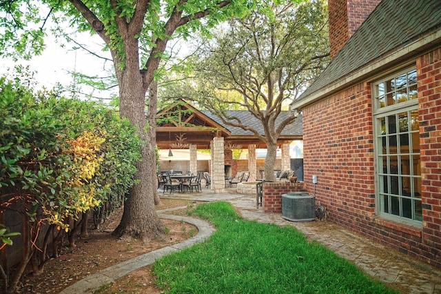 view of yard with a patio area and central air condition unit