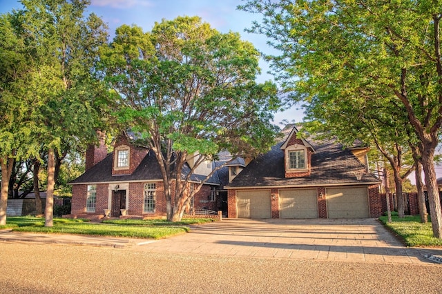 cape cod home with a garage