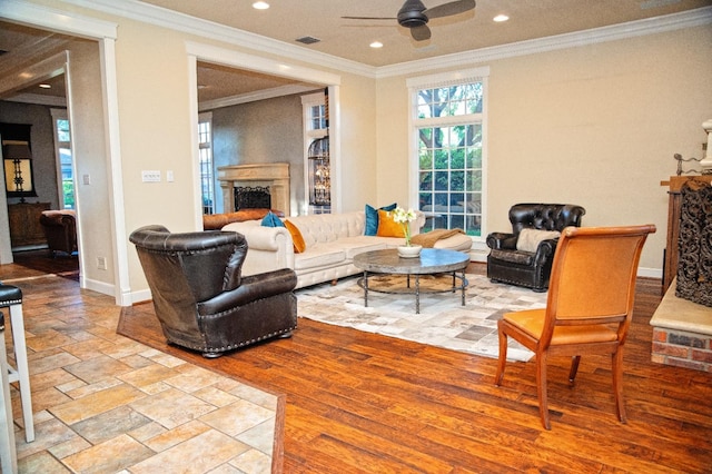 living room with crown molding, light hardwood / wood-style floors, and ceiling fan