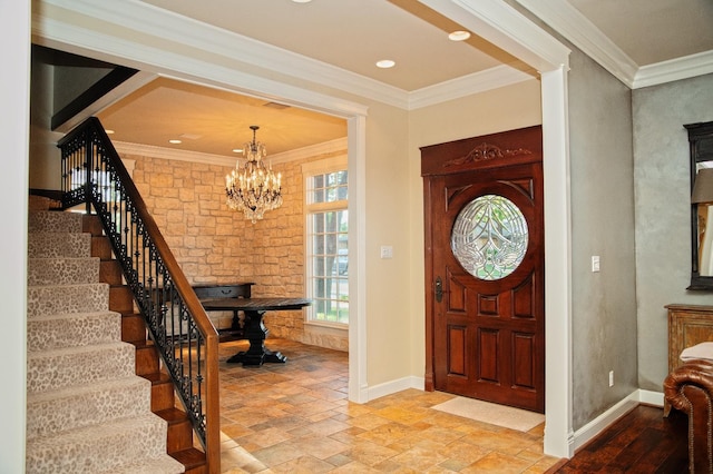 entryway featuring ornamental molding and a chandelier