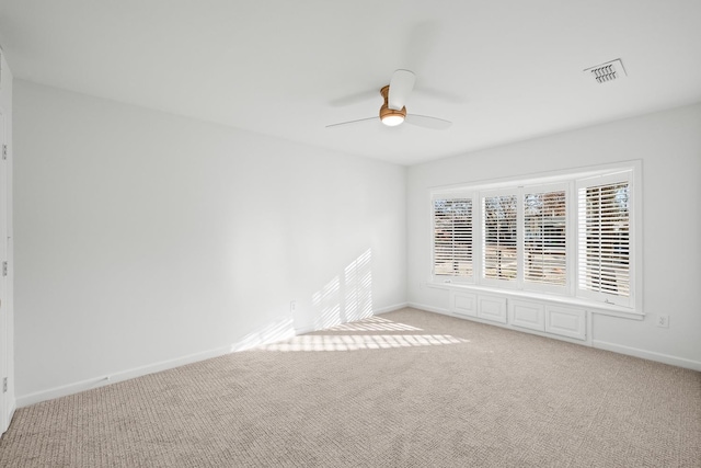 spare room with light colored carpet and ceiling fan