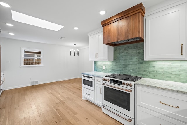 kitchen featuring high end white range oven and white cabinets