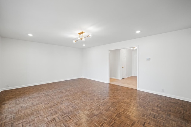 spare room with dark parquet flooring