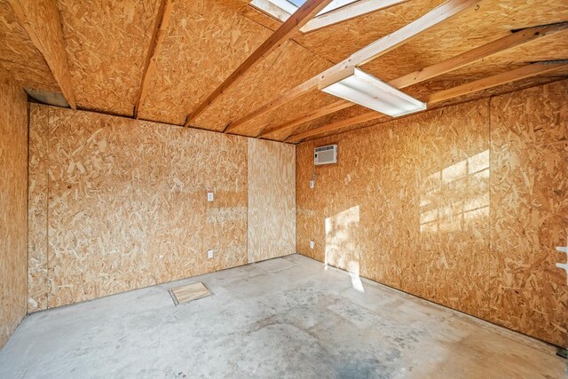 empty room featuring concrete floors and a wall mounted AC