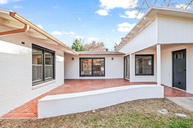 property entrance featuring a patio area