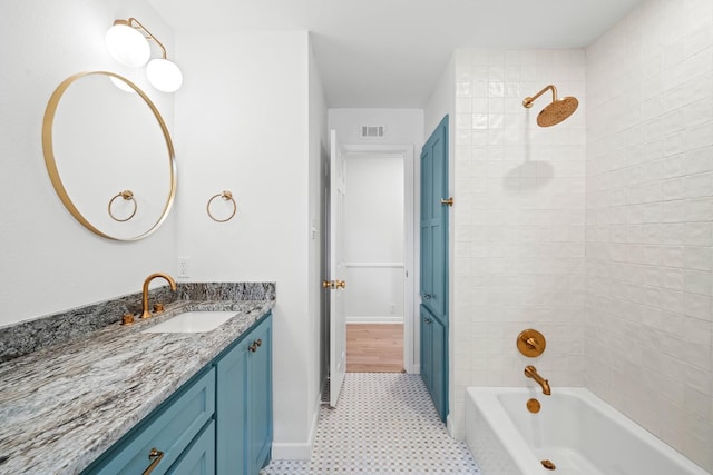 bathroom with vanity and tiled shower / bath combo