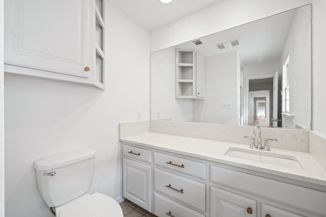 bathroom with tile patterned floors, vanity, and toilet