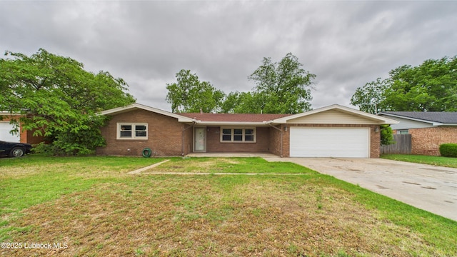 3811 42nd St, Lubbock, TX 79413 - ranch-style house featuring a garage, concrete driveway, and brick siding
