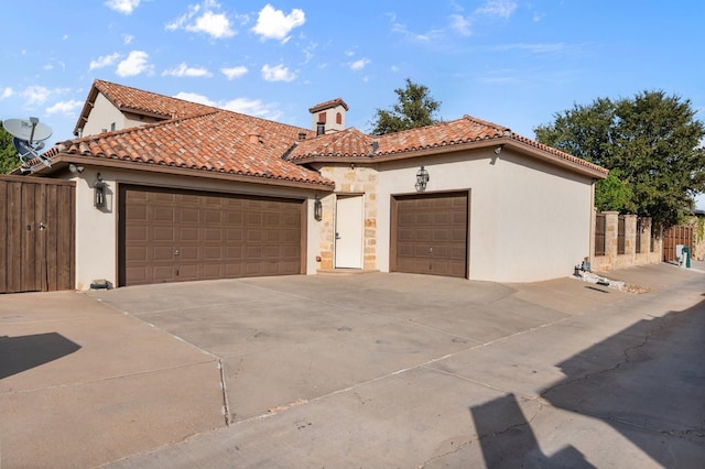 mediterranean / spanish house featuring a garage