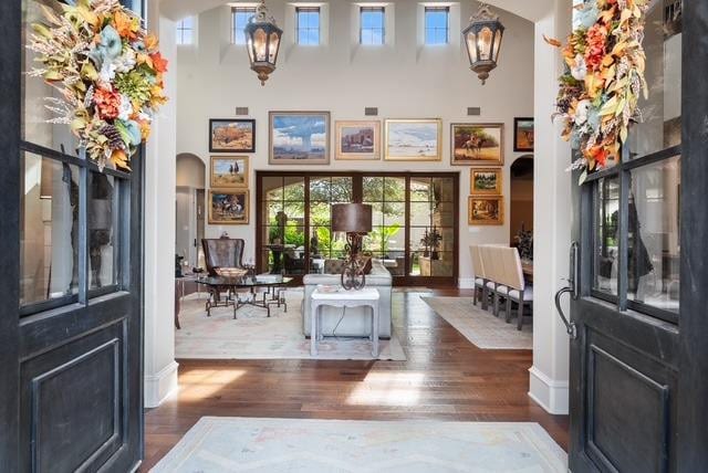 entrance foyer with dark hardwood / wood-style flooring and a high ceiling