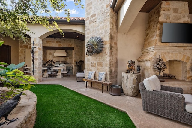 view of patio / terrace with an outdoor stone fireplace