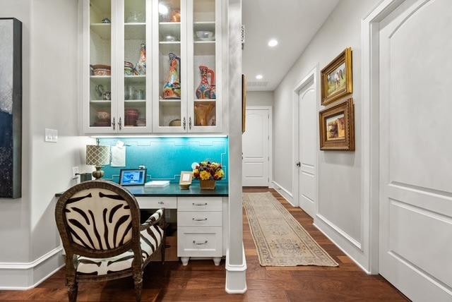 office area featuring dark wood-type flooring and built in desk