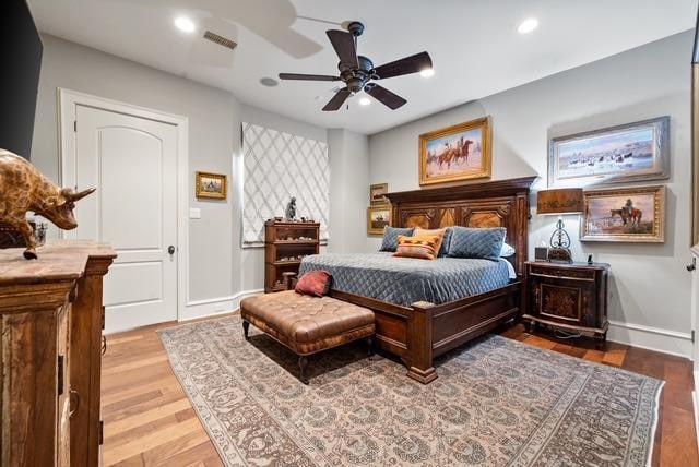 bedroom with wood-type flooring and ceiling fan