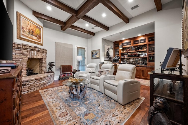 living room with bar, coffered ceiling, a brick fireplace, dark hardwood / wood-style floors, and beam ceiling