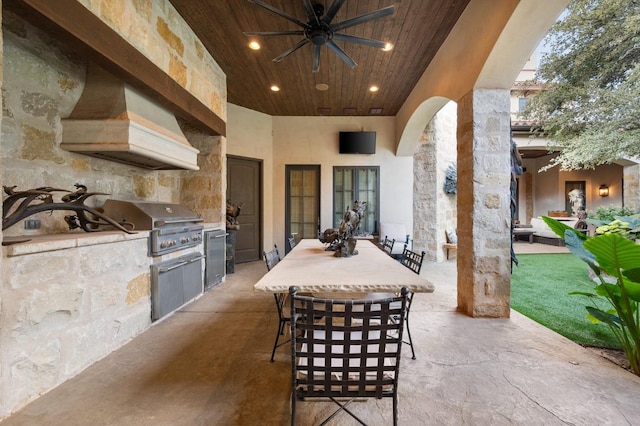 view of patio with grilling area, ceiling fan, and exterior kitchen