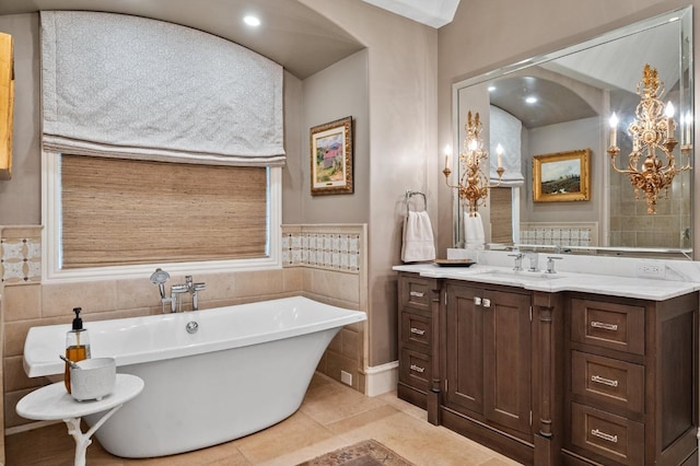 bathroom featuring vanity, tile patterned floors, and a tub to relax in