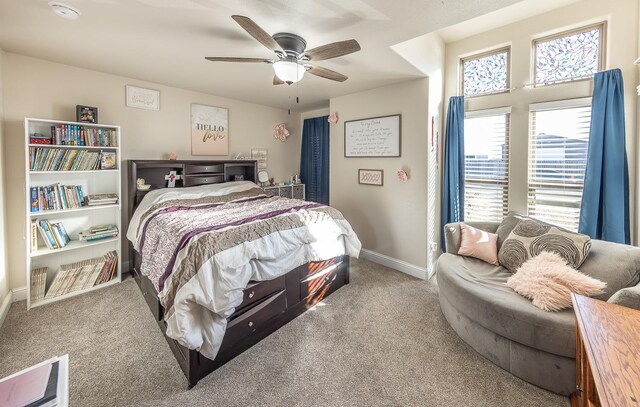 bedroom with ceiling fan and light carpet