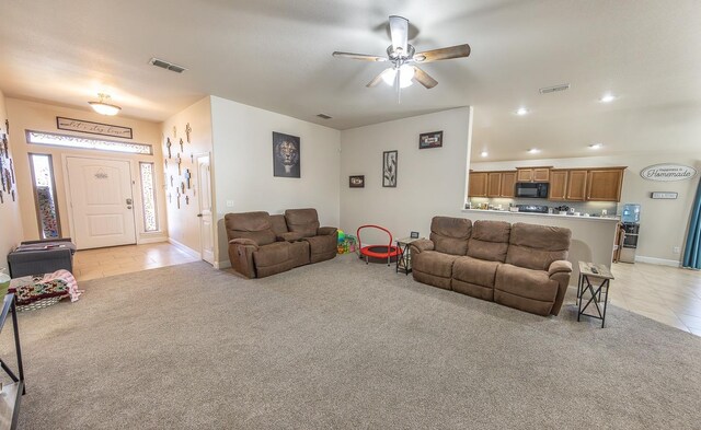 living room with ceiling fan and light tile patterned floors