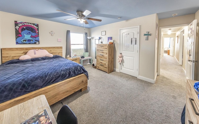 bedroom with ceiling fan and light carpet