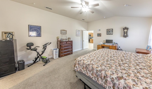 carpeted bedroom featuring ensuite bath, vaulted ceiling, and ceiling fan