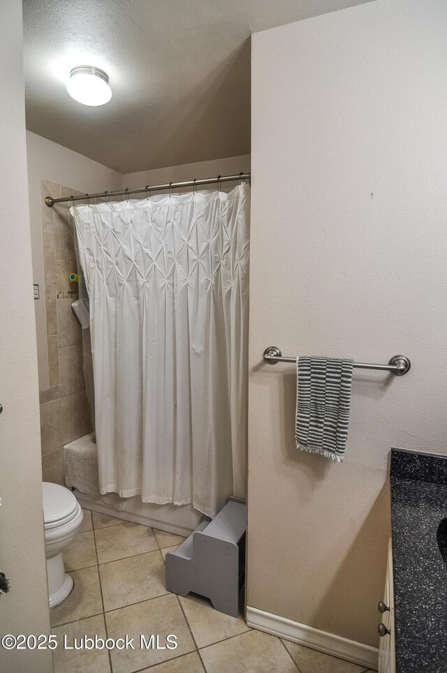 5309 77th St, Lubbock, TX 79424 - full bath with vanity, toilet, tile patterned floors, and shower / bath combination with curtain